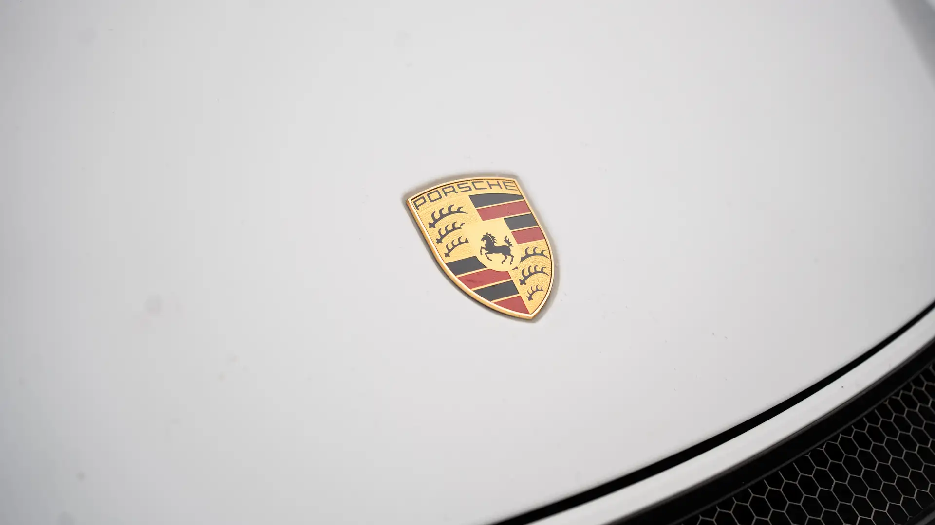 The logo on the hood of our Porsche GT4.